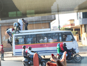 A typical scene in Mumbai (formerly known as Bombay): people sitting on the top public buses and even trains, hanging off the sides and jumping on and off even as they’re moving.