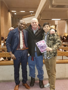 Jeff Kramer, center, accompanies two refugees he works with at InterFaith Works in Syracuse to the Syracuse Opera production of “La Traviata” recently.