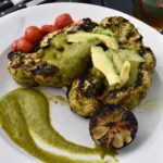 Grilled “steaks” were thick-cut center pieces of cauliflower crowns grilled very well and topped with avocado slices, and roasted tomatoes. 