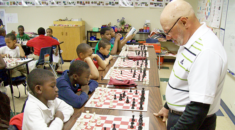 Bob Nasiff, 73, a certified chess master with the U.S. Chess Federation, playing chess with students at Southside Academy in Syracuse.
