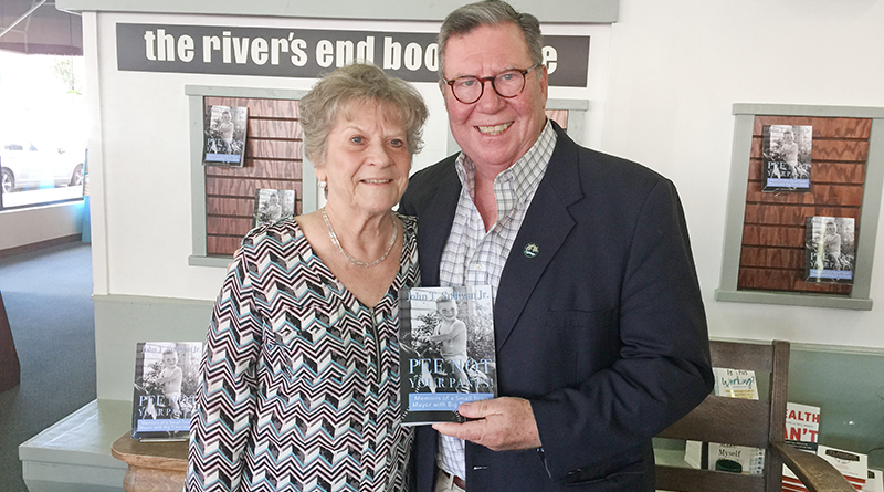 Former City of Oswego Mayor John T. Sullivan, right, is congratulated by Jeanne Byrne, secretary to City of Oswego Mayor William “Billy Barlow,” at a recent booksigning at the river’s end bookstore in Oswego.
