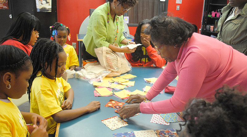Dorothy (“Dottie”) White teaching kids at Southwest Community Center in Syracuse the basics of quilting.
