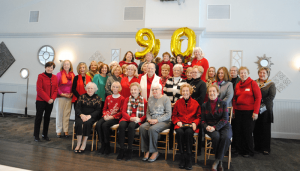 Members of the Tuesday Book Club pose during the group’s 90th anniversary celebration at Traditions at the Links in East Syracuse.