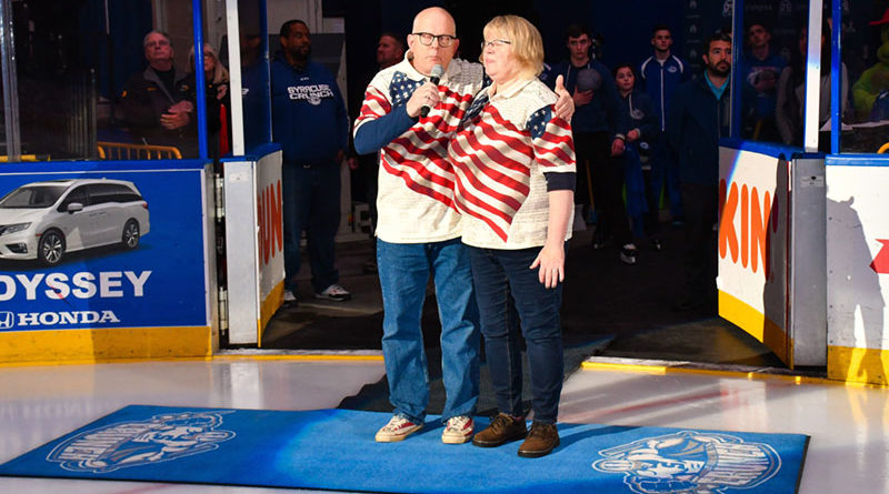 Chuck and Betsy Copps sing the National Anthem before a Syracuse Crunch hockey game. Courtesy of Scott Thomas Photography.