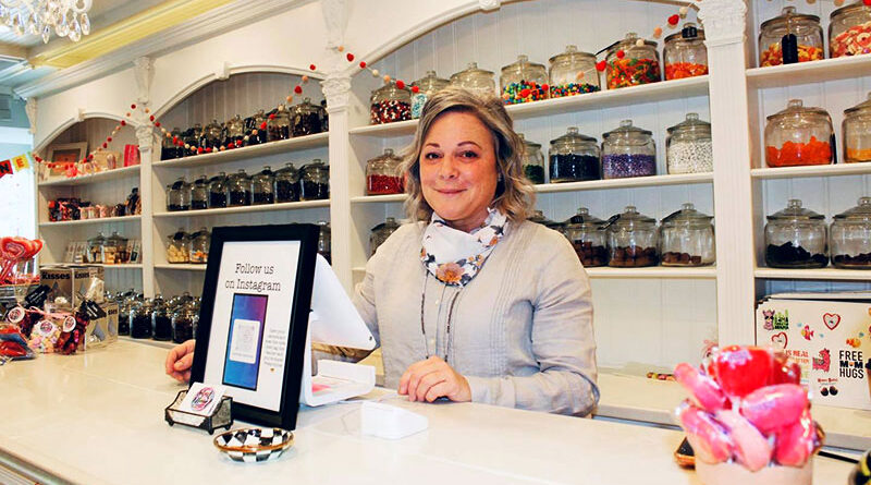Robin Mack stands at the register of her Sweet Dream Candy Shoppe, which she opened at 55 years old.