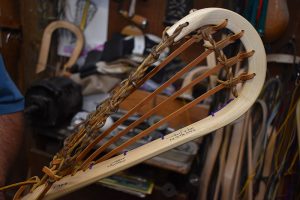 One of the final steps is outfitting the head of the stick with genuine woven rawhide and nylon. 