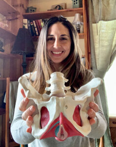 Rebecca Alexander Carey, senior physical therapist at SUNY Upstate, holding a model of the pelvic floor. She says physical therapy helps patients to retrain certain muscles, which will help control urinary or bowel incontinence.