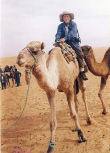 Molly Fulton rides a camel, she is unsure of the location.