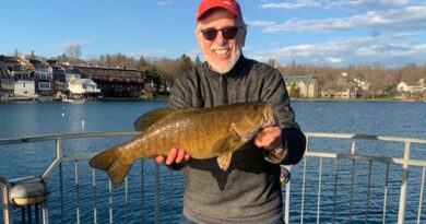 David Figura with a lunker smallmouth bass he caught and released  recently while fishing off the Skaneateles Village Pier. Photo provided.