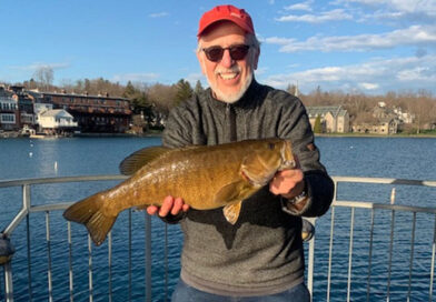 David Figura with a lunker smallmouth bass he caught and released  recently while fishing off the Skaneateles Village Pier. Photo provided.
